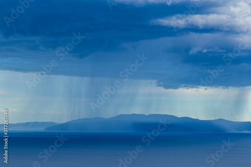 Dramatic storm scenery over the Adriatic Sea, with dark cumulus rain clouds