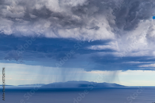 Dramatic storm scenery over the Adriatic Sea, with dark cumulus rain clouds