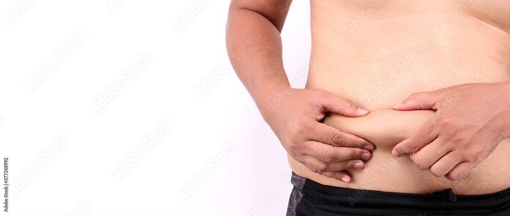 Close up of fatty Men's hand catching his fat belly or Man's hand grabbing his fat on white background in studio With copy space. Close up of fatty Men's hand catching his fat belly or Man's hand grabbing his fat on white background in studio With copy space.