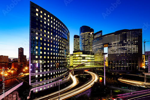 Night view of the Paris La Défense business district and headquarters of . corporation and multinational firm illuminated at the blue hours