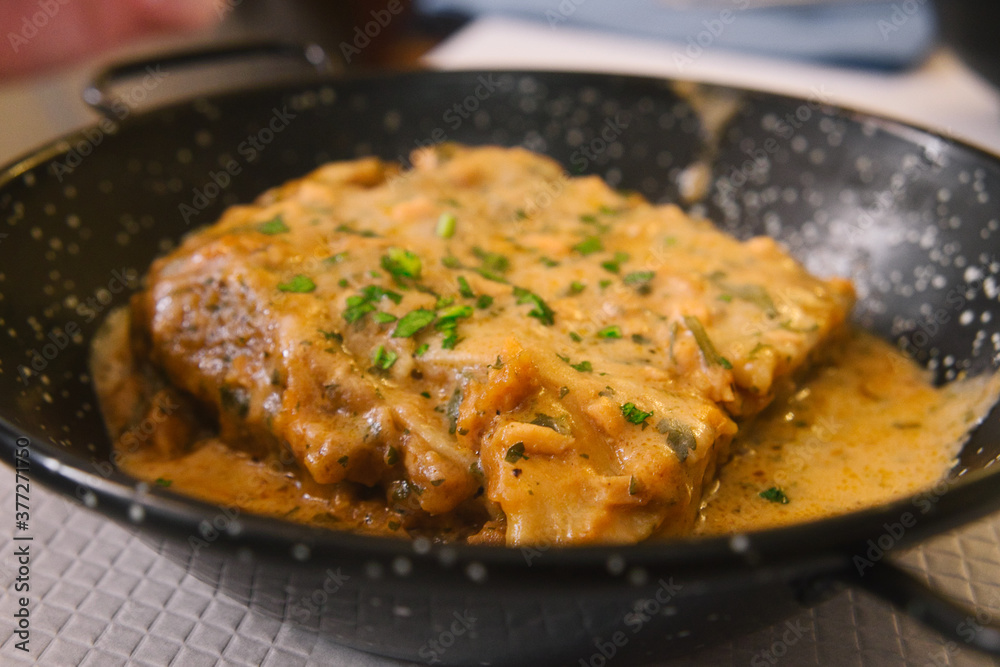 A piece of delicious Italian lasagna in rich fish sauce A piece of delicious Italian lasagna in rich fish sauce