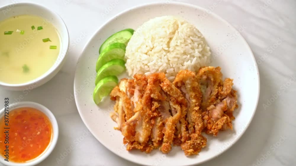 Hainanese chicken rice with fried chicken or rice steamed chicken soup with fried chicken - Asian food style Hainanese chicken rice with fried chicken or rice steamed chicken soup with fried chicken - Asian food style