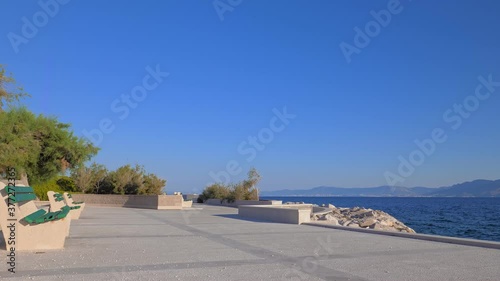 Promenade along the Adriatic coast, Postira, island of Brac, Croatia. A beautiful summer morning. Empty streets, corona virus pandemic concept.
