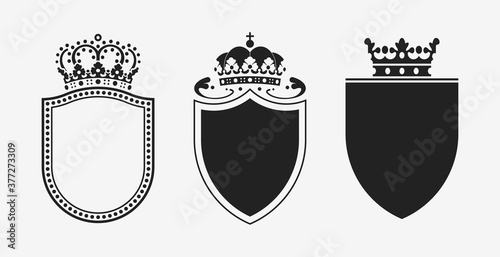 Set of crowns with shields. Black heraldic decoration vector elements.