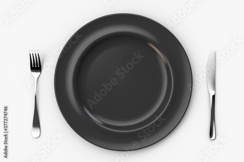 Empty black plate. Knife on the right and fork on the left. View from above.