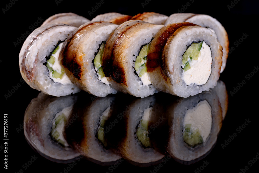 Fresh delicious beautiful sushi rolls on a dark background Fresh delicious beautiful sushi rolls on a dark background