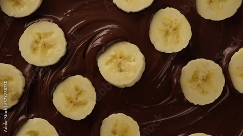 melted chocolate and sliced banana top view rotating photo