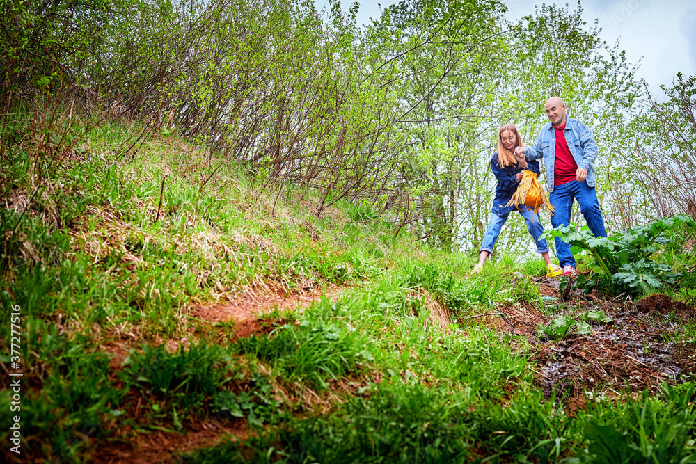 Kirov, Russia - June 22, 2020: European couple of blonde woman and bald man walking at park, enjoying and being happy together. Love and tenderness concept. Lovers on date outdoors at nature. Kirov, Russia - June 22, 2020: European couple of blonde woman and bald man walking at park, enjoying and being happy together. Love and tenderness concept. Lovers on date outdoors at nature.