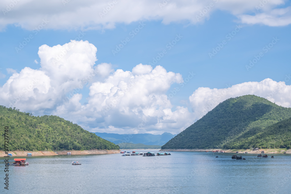 The beauty inside the dam and the houseboat on the bright sky at Sri Nakarin dam , Kanchana buri in Thailand.