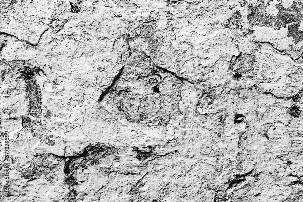 Fototapeta premium Texture of a concrete wall with cracks and scratches which can be used as a background