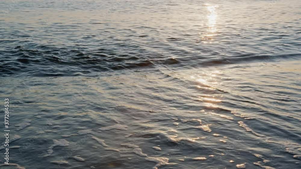 Small waves reach the beach on beautiful golden hour, 4k slow-motion Small waves reach the beach on beautiful golden hour, 4k slow-motion