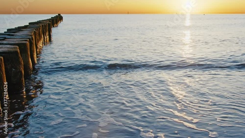 Wallpaper Mural Small waves reach the beach while camera slides slowly to the right, beautiful sunrise, 4k Torontodigital.ca