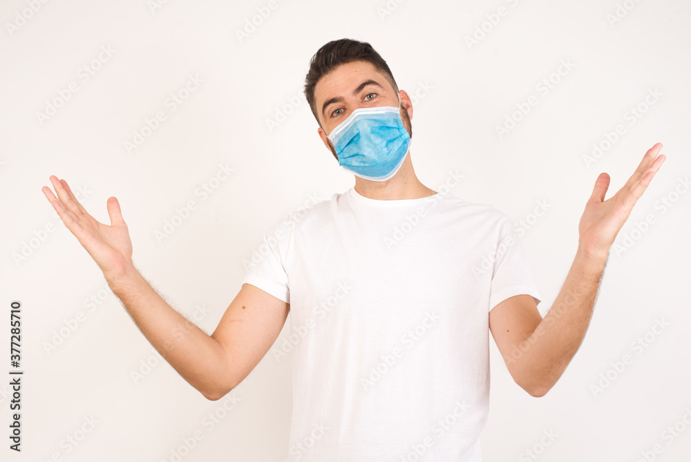 Cheerful man making a welcome gesture raising arms over head isolated on white background. Cheerful man making a welcome gesture raising arms over head isolated on white background.