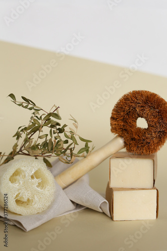 Classic wooden dish brush near eco handmade soap and loofah sponge. photo