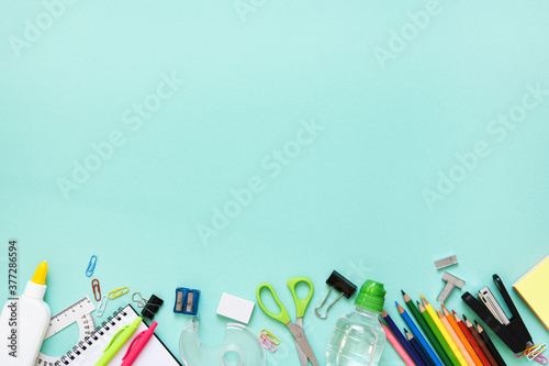 Back to school. School accessories on paper mint background. Layout.