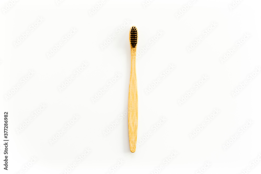 Eco materials concept with bamboo tooth brush on white background top view copy space Eco materials concept with bamboo tooth brush on white background top view copy space
