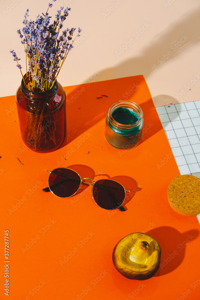 Φωτογραφία Fashionable sunglasses, lavender flowers, candle and mushroom on colorful bright orange and white background
