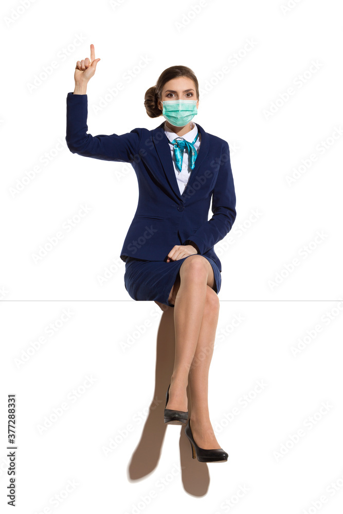Excited Air Stewardess Sitting And Pointing Up Excited Air Stewardess Sitting And Pointing Up