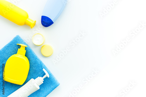Bath cosmetics and Toy for child. Shampoo, gel, cream, soap and towel. White background top view