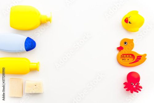 Bath cosmetics and Toy for child. Shampoo, gel, cream, soap and towel. White background top view