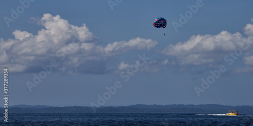 Kids enjoying parasailing in the pristine waters at the beach at Andaman's.