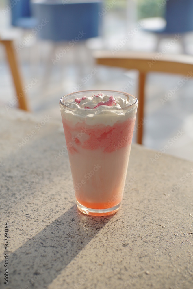 Strawberry milkshake on top of a table from several angle Strawberry milkshake on top of a table from several angle