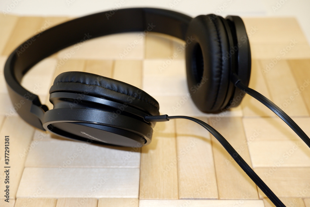 headphones on a wooden surface headphones on a wooden surface