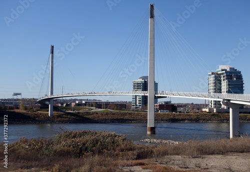The Bob Kerrey Pedestrian Bridge crosses over the river, connecting Omaha, Nebraska with Council Bluffs, Iowa photo