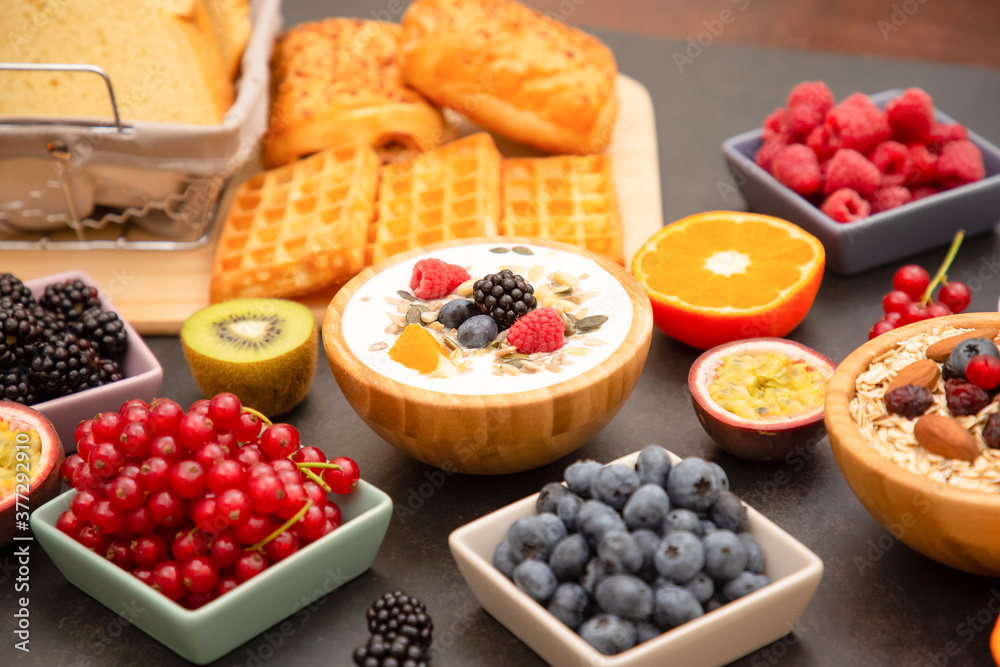 Breakfast Served in the morning with Butter bread and corn flakes Whole grains and raisins with milk in cups and Strawberry, Blueberry, Raspberry, Kiwi, Fresh Orange on the breakfast table. Breakfast Served in the morning with Butter bread and corn flakes Whole grains and raisins with milk in cups and Strawberry, Blueberry, Raspberry, Kiwi, Fresh Orange on the breakfast table.