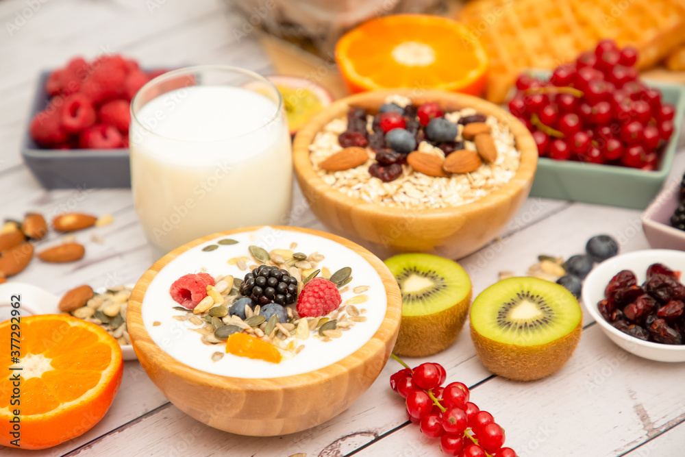 Breakfast Served in the morning with Butter bread and corn flakes Whole grains and raisins with milk in cups and Strawberry, Blueberry, Raspberry, Kiwi, Fresh Orange on the breakfast table. Breakfast Served in the morning with Butter bread and corn flakes Whole grains and raisins with milk in cups and Strawberry, Blueberry, Raspberry, Kiwi, Fresh Orange on the breakfast table.