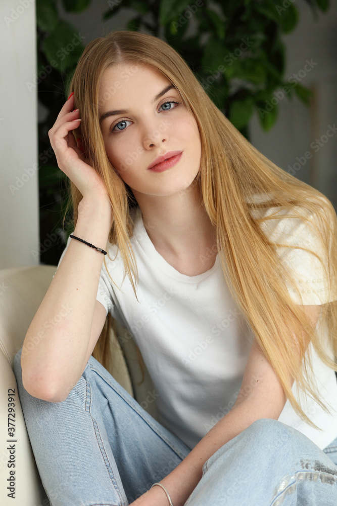 A woman sitting on the sofa in the living room.. Stay home to stop spreading covid-19 concept. A woman sitting on the sofa in the living room.. Stay home to stop spreading covid-19 concept.