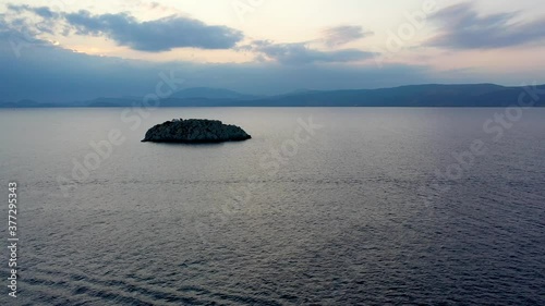 A small island in front of Vlychos Plakes Beach in Hydra Island, Greece photo