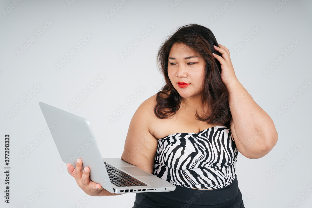 Asian chubby businesswoman using computer laptop on white background. Asian chubby businesswoman using computer laptop on white background.