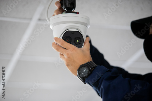 Technician installing IP wireless CCTV camera by screwed for home security system and installed photo