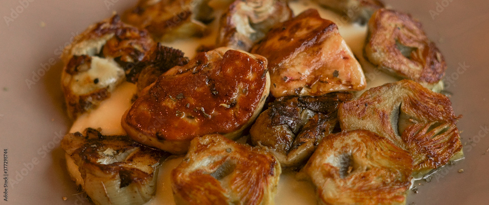 Roasted artichokes with foie served with a delicious white sauce Roasted artichokes with foie served with a delicious white sauce