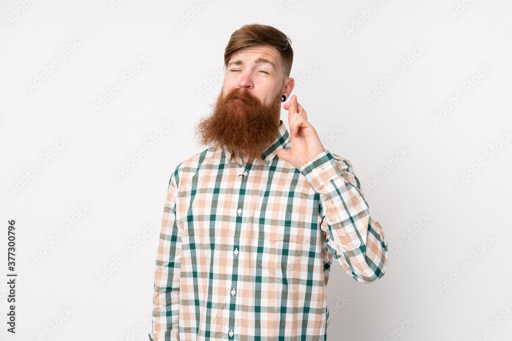 Redhead man with long beard over isolated white background with fingers crossing and wishing the best Redhead man with long beard over isolated white background with fingers crossing and wishing the best