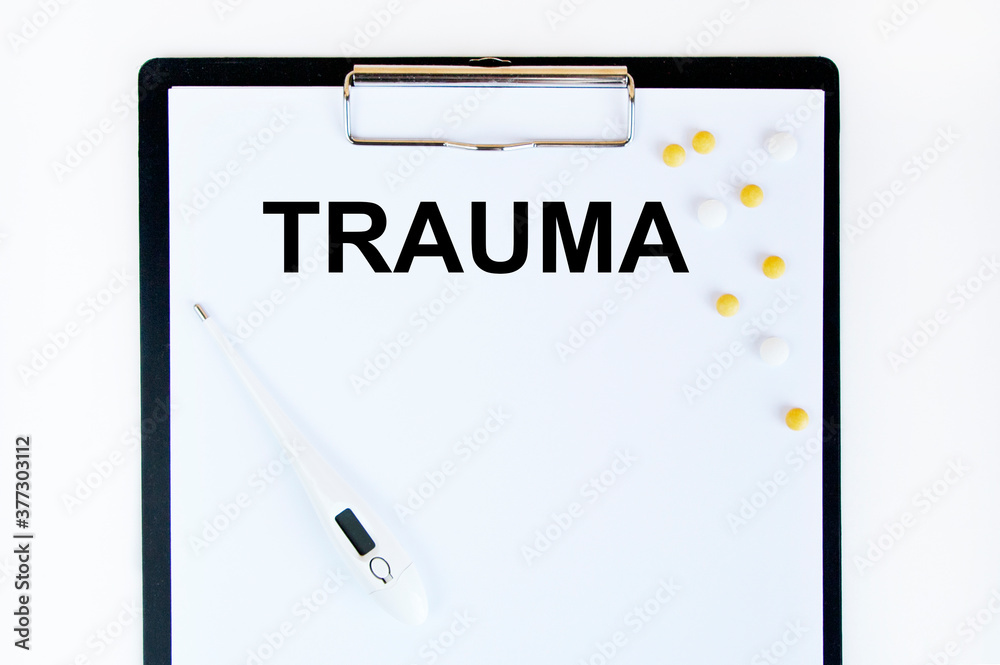 The inscription on the TRAUMA business card, next to the white tablets. The inscription on the TRAUMA business card, next to the white tablets.