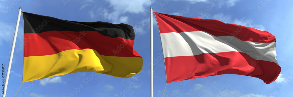 Naklejka premium Flags of Germany and Austria on flagpoles. 3d rendering
