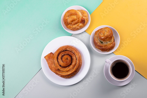 a cup of espresso and cinnamon roll
