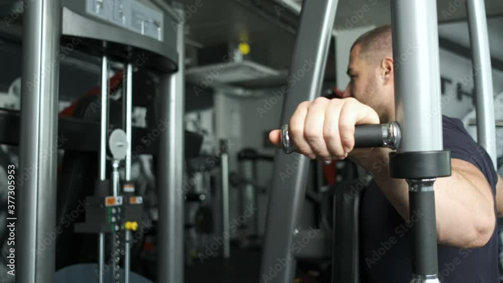 Caucasian pumped athlete doing another arm exercise in the gym in preparation for competitions. Healthy Lifestyle Caucasian pumped athlete doing another arm exercise in the gym in preparation for competitions. Healthy Lifestyle