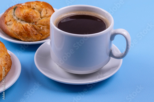 a cup of espresso and cinnamon roll