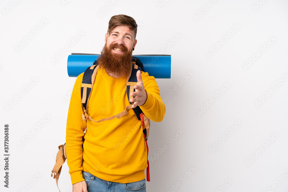 Young mountaineer man with a big backpack over isolated white background handshaking after good deal Young mountaineer man with a big backpack over isolated white background handshaking after good deal