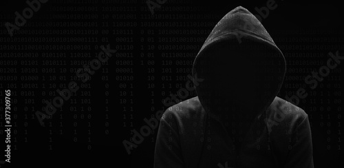 dark mysterious man in a hoodie is hiding his face, hacker, anonymous