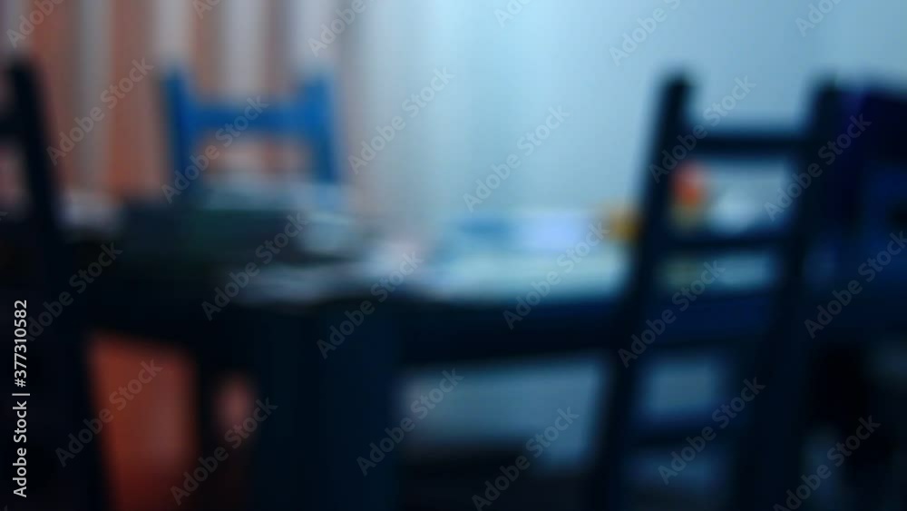 A chair near the table, out of focus room, home. Empty. Scary. A chair near the table, out of focus room, home. Empty. Scary.