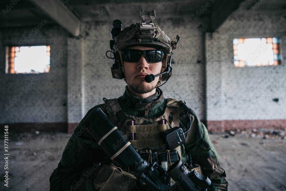 Fototapeta premium Soldier preparing tactical gear for action battle