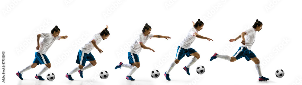 Flying. Football player in motion and action isolated on white background, kicking ball in dynamic. Concept of activity, movement, healthy lifestyle, expression of sport. Young male sportsman.