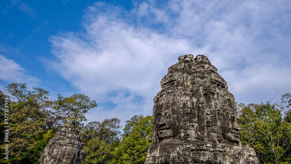Stone-carved faces in Angkor Thom complex during Khmer empire, Siem Reap, Cambodia. 