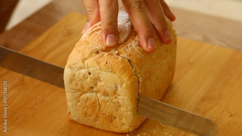 Cutting bread on board , in door Chiangmai Thailand Cutting bread on board , in door Chiangmai Thailand