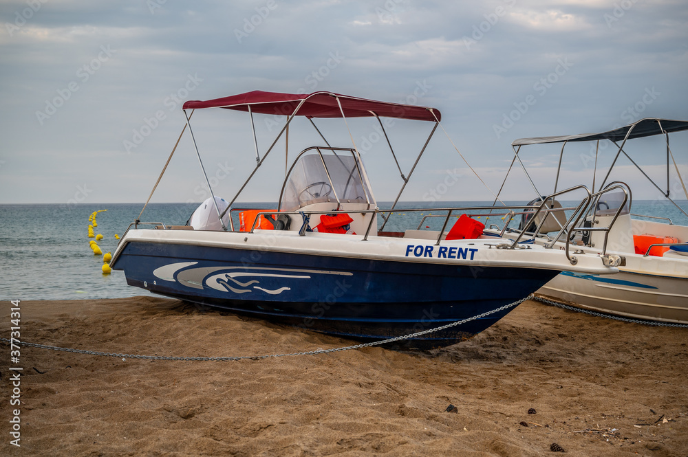 Naklejka premium Small boats for rent, on a beach in Corfu, Greece