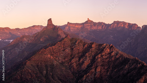 Sun setting between the mountains of Gran Canaria, you can see Roque Bentayga and Roque Nublo in the background. © Israel